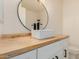 Bathroom vanity featuring white vessel sink, modern faucet, and wood countertop at 4640 W Gail Dr, Chandler, AZ 85226