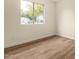 Bedroom with natural light from a large window and wood-look flooring at 4640 W Gail Dr, Chandler, AZ 85226