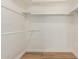 A well-lit, reach-in closet with wood floor and ample storage space at 4640 W Gail Dr, Chandler, AZ 85226