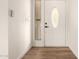 Entryway featuring a white door with decorative glass and matching hardwood floors at 4640 W Gail Dr, Chandler, AZ 85226