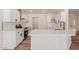 Well-lit kitchen features white cabinets, stainless steel appliances, and an eat-in island at 4640 W Gail Dr, Chandler, AZ 85226