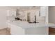Open kitchen boasts white cabinets, stainless steel appliances, and a large island at 4640 W Gail Dr, Chandler, AZ 85226