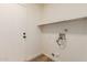 Laundry room with wood floors, shelving, and utilities at 4640 W Gail Dr, Chandler, AZ 85226
