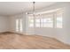Bright living room features wood floors, neutral paint, and updated lighting at 4640 W Gail Dr, Chandler, AZ 85226