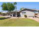 Spacious backyard featuring a covered patio and lush green lawn, perfect for outdoor gatherings at 4711 S Los Feliz Dr, Tempe, AZ 85282