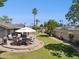 Outdoor patio seating on a well-maintained lawn with mature trees and privacy fence, perfect for entertaining and relaxing at 4711 S Los Feliz Dr, Tempe, AZ 85282