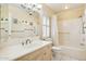 A well-lit bathroom features a tiled shower/tub combo, safety bars and a single sink vanity at 4711 S Los Feliz Dr, Tempe, AZ 85282