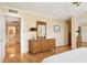 Bedroom with hardwood floors leads to a full bathroom and has a decorative mirrored dresser at 4711 S Los Feliz Dr, Tempe, AZ 85282