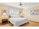 Comfortable bedroom featuring hardwood floors, a ceiling fan and a window with plantation shutters at 4711 S Los Feliz Dr, Tempe, AZ 85282