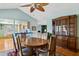 Open-concept dining area with a wooden table, seating for six, and view into the kitchen at 4711 S Los Feliz Dr, Tempe, AZ 85282
