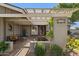 Inviting front entrance with shaded seating area, mature plants, and decorative water feature at 4711 S Los Feliz Dr, Tempe, AZ 85282