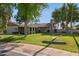 Charming single-story home with lush green lawn and mature trees in a well-maintained neighborhood at 4711 S Los Feliz Dr, Tempe, AZ 85282