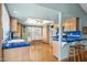 Bright kitchen with light cabinets, stainless appliances, blue tile countertops, and adjacent dining area at 4711 S Los Feliz Dr, Tempe, AZ 85282