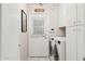 Clean laundry area showcasing white cabinets and modern washer and dryer units at 4711 S Los Feliz Dr, Tempe, AZ 85282