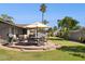 Paver patio with outdoor seating, a grill, and a large sun umbrella create an inviting outdoor living space at 4711 S Los Feliz Dr, Tempe, AZ 85282