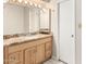 Bathroom featuring modern vanity, light fixtures, a mirror and white door at 5208 S Deborah Dr, Tempe, AZ 85283