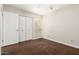 Bright bedroom featuring a ceiling fan, closet with white doors and natural light at 5208 S Deborah Dr, Tempe, AZ 85283