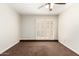 Bedroom with light walls, carpet and fan. Access to outside with shutter doors at 5208 S Deborah Dr, Tempe, AZ 85283