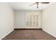 Bedroom with light walls, carpet and fan. Access to outside with shutter doors at 5208 S Deborah Dr, Tempe, AZ 85283