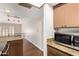 Kitchen with granite countertops and stainless steel microwave adjacent to the living room at 5208 S Deborah Dr, Tempe, AZ 85283