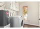 Well lit laundry room featuring a newer washer and dryer, with white cabinets at 5208 S Deborah Dr, Tempe, AZ 85283
