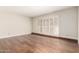 Bright living room featuring attractive wood floors and shuttered doors at 5208 S Deborah Dr, Tempe, AZ 85283