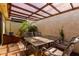 Outdoor patio with a tiled floor, wrought iron table set, and privacy wall with tropical plants at 5208 S Deborah Dr, Tempe, AZ 85283