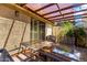 Cozy outdoor patio with a glass-top wrought iron table, chairs, and tropical plants, offering a relaxing retreat at 5208 S Deborah Dr, Tempe, AZ 85283