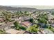 This aerial view shows a property with a backyard playhouse, pool and a beautiful mountain backdrop at 5602 W Alameda Rd, Glendale, AZ 85310