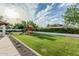 Spacious backyard features a playhouse and lush landscaping, ideal for Gathering activities at 5602 W Alameda Rd, Glendale, AZ 85310