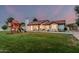 Expansive backyard with lush lawn and a charming playhouse, perfect for outdoor enjoyment at 5602 W Alameda Rd, Glendale, AZ 85310