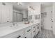 Bathroom featuring dual sinks, decorative towels, and large mirror at 5602 W Alameda Rd, Glendale, AZ 85310