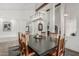 Elegant dining room features wooden table, exposed beams, pillars and modern light fixture at 5602 W Alameda Rd, Glendale, AZ 85310