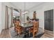Bright dining room with wooden table and chairs under a modern light fixture, and large windows at 5602 W Alameda Rd, Glendale, AZ 85310