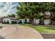 Expansive home with a circular driveway, mature landscaping, and a well-maintained lawn at 5602 W Alameda Rd, Glendale, AZ 85310
