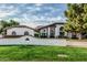 Single-Gathering home boasts a mature landscape, lush lawn, and charming brick-accented retaining wall at 5602 W Alameda Rd, Glendale, AZ 85310