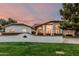 Stunning single-Gathering home boasts a mature landscape, lush lawn, and charming brick-accented retaining wall at 5602 W Alameda Rd, Glendale, AZ 85310