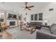 Spacious living room with a white mantel fireplace, plush sofas, ceiling fan and neutral decor at 5602 W Alameda Rd, Glendale, AZ 85310