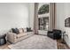 Bright living room featuring neutral tones, a cozy couch, and a plush armchair at 5602 W Alameda Rd, Glendale, AZ 85310