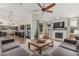 Open floor plan living room featuring a fireplace, kitchen view and comfortable seating arrangement at 5602 W Alameda Rd, Glendale, AZ 85310