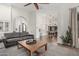 Open-concept living room with gray sofa, wooden coffee table and view of the kitchen at 5602 W Alameda Rd, Glendale, AZ 85310
