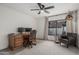 Comfortable home office with a ceiling fan, large window, and a leather chair at 5602 W Alameda Rd, Glendale, AZ 85310