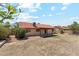 Exterior backyard with covered patio and a well-maintained yard with red tiled roof at 5852 E Enrose St, Mesa, AZ 85205