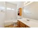 Traditional white bathroom with a tiled shower/tub combo and wood vanity with a white countertop at 5852 E Enrose St, Mesa, AZ 85205