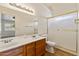 Bathroom featuring double sinks, frosted glass shower, and a tile floor at 5852 E Enrose St, Mesa, AZ 85205