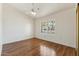 Bright bedroom with hardwood floors, ceiling fan and plantation shutters at 5852 E Enrose St, Mesa, AZ 85205