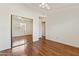 Clean, bright bedroom with wood floors, mirrored closet, and access to a door at 5852 E Enrose St, Mesa, AZ 85205