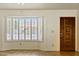 Bright entryway featuring a bay window with shutter and a solid wood door at 5852 E Enrose St, Mesa, AZ 85205
