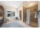 A bright bathroom with tiled shower, soaking tub, vanity and a view of the backyard at 6101 W Grandview Rd, Glendale, AZ 85306