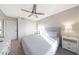 Cozy bedroom featuring neutral tones, a ceiling fan, and ample closet space for organized storage at 6101 W Grandview Rd, Glendale, AZ 85306